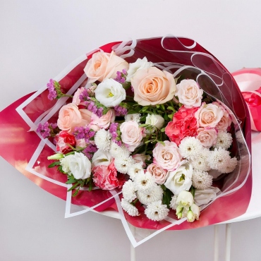 Athos poms Stallion - 3, Spray rose 50 cm (multiple small blooms on a stem) - 3, Rose Cream 50 cm - 3, Carnations - 3, lisianthus - 1, Blue Statice, Pistachio, Wrapping Paper, Ribbon