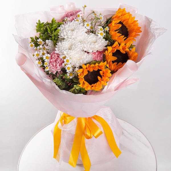 Sunflower - 3, Baltica White Spray Chrysanthemum - 1, Chamomile - 2, Pink carnation - 9, Pistachio, Wrapping Paper